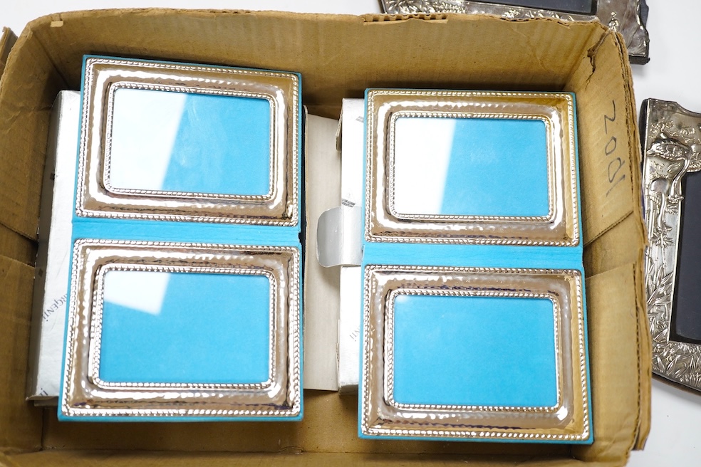 A pair of modern silver mounted 'Chinoiserie' photograph frames, London, 1986, 18.7cm, together with four other modern silver mounted photograph frames including two doubles and one decorated with a fisherman. Condition